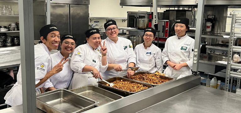 Culinary learners pose for a group photo with the chilli they prepared.